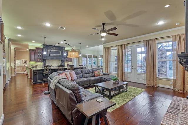 a spacious bedroom with a bed and a chandelier