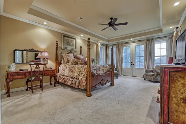 a bedroom with a bed and ceiling fan