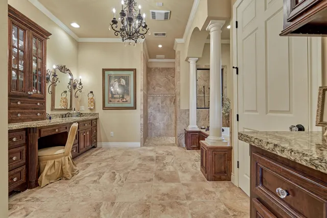 a bathroom with a granite countertop toilet a sink and a mirror
