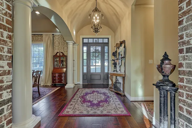 a living room with fireplace furniture and a wooden floor