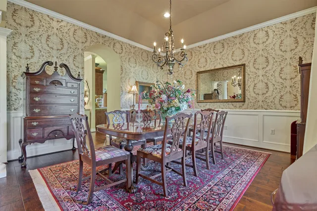 a living room with furniture a fireplace and a chandelier