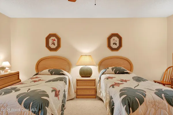 a bed with a bed and a painting on the wall