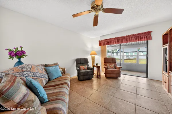 a living room with furniture and a floor to ceiling window