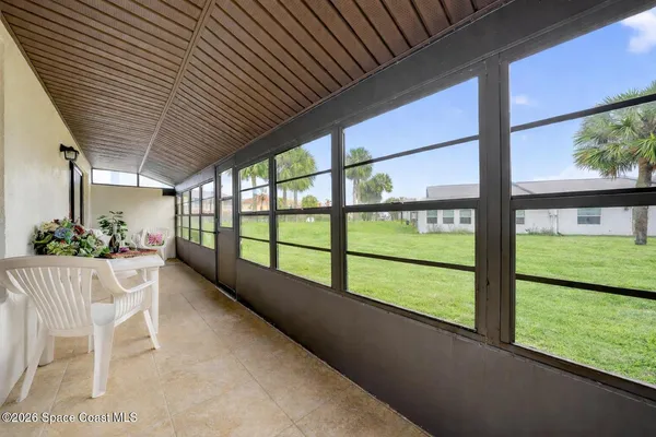 a view of porch with a bench in dining space