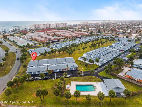 an aerial view of residential houses with outdoor space