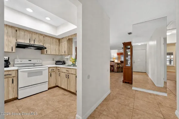 a kitchen with white cabinets and appliances
