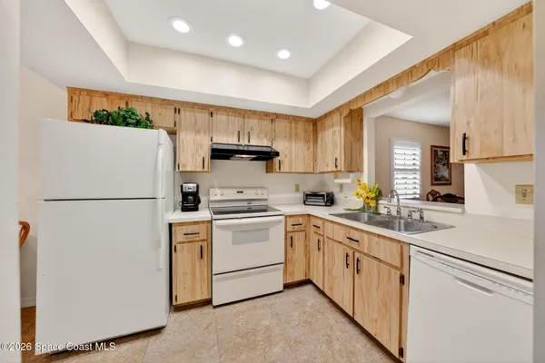a kitchen with cabinets a refrigerator and a sink