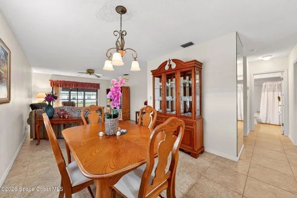 a dining room with furniture and chandelier