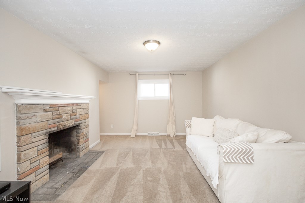 1646 Harwich Road Cleveland, OH 44124 - Photo 11 of 39 Carpeted family room with a stone fireplace