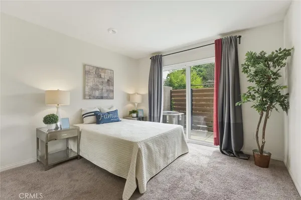 a bedroom with a bed and a large window