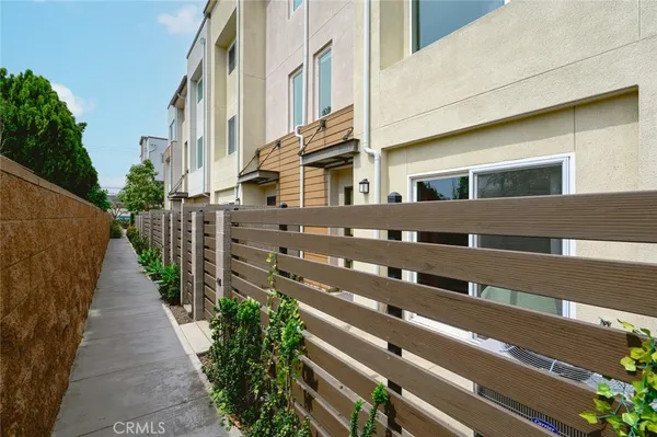 a view of a house with wooden fence