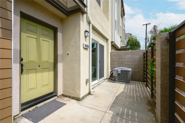 a view of a door with a patio and a yard