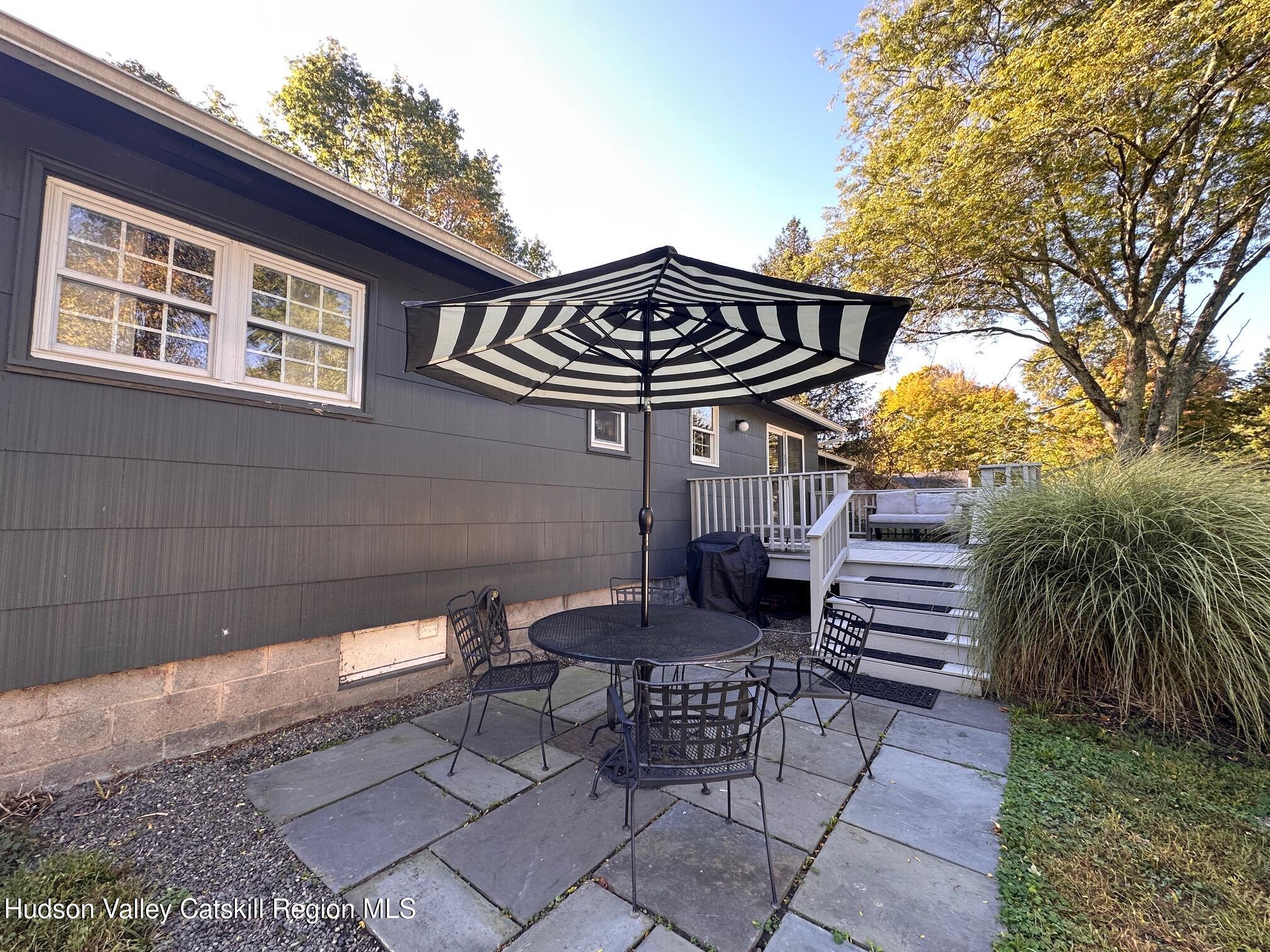 49 George Saile Road Saugerties, NY 12477 - Photo 19 of 23 a view of a patio with a table and chairs and potted plants