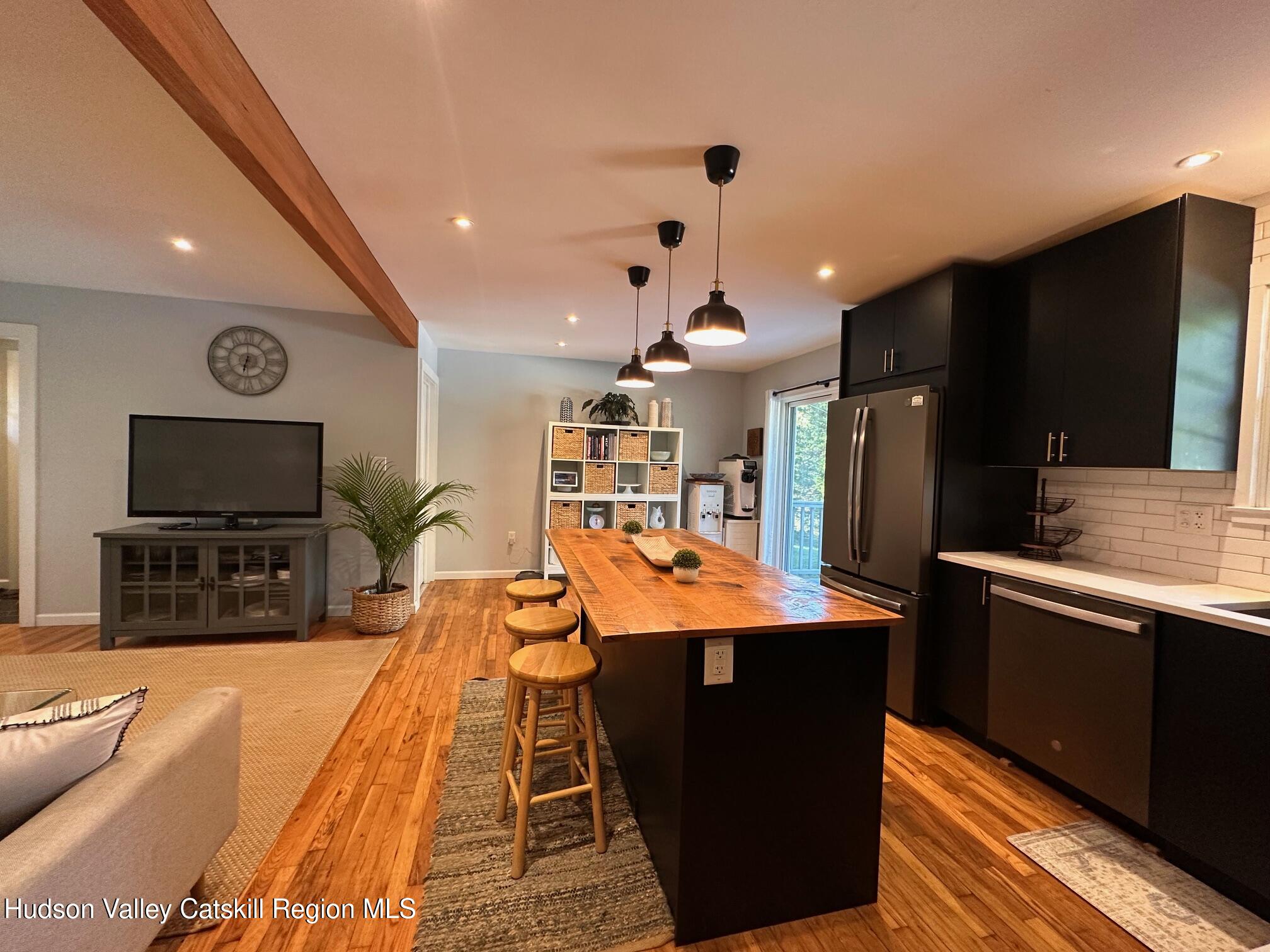 49 George Saile Road Saugerties, NY 12477 - Photo 7 of 23 a dining hall with stainless steel appliances kitchen island granite countertop a refrigerator a stove a sink and a dining table with wooden floor