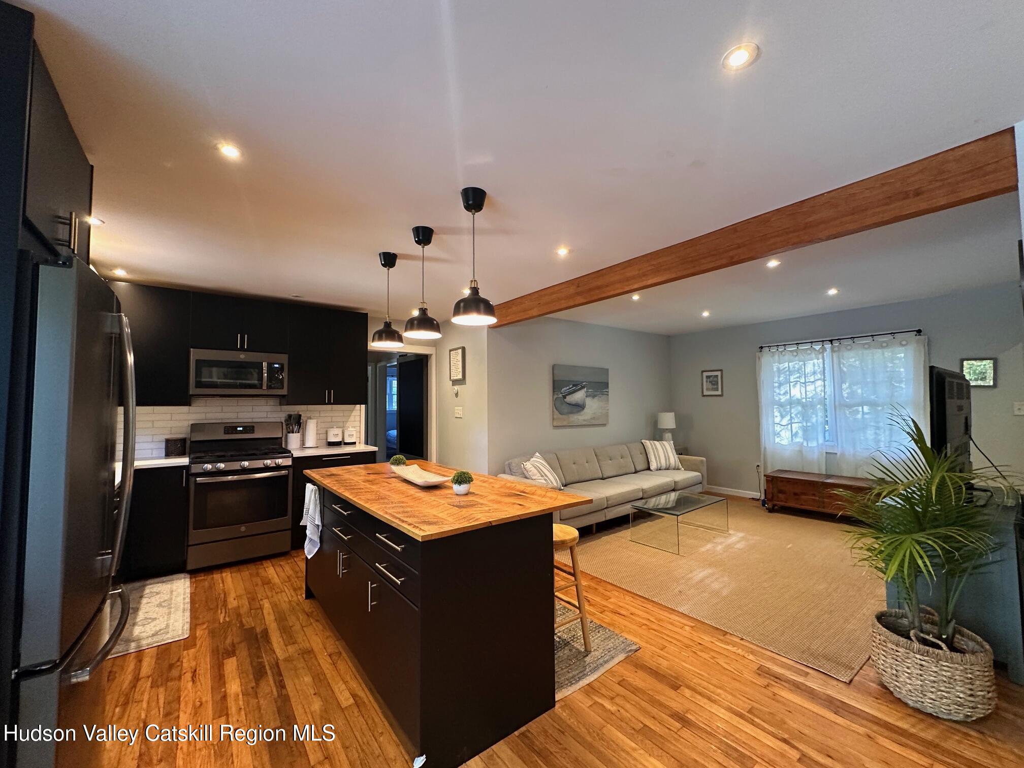 49 George Saile Road Saugerties, NY 12477 - Photo 9 of 23 a large kitchen with stainless steel appliances granite countertop a sink stove and refrigerator