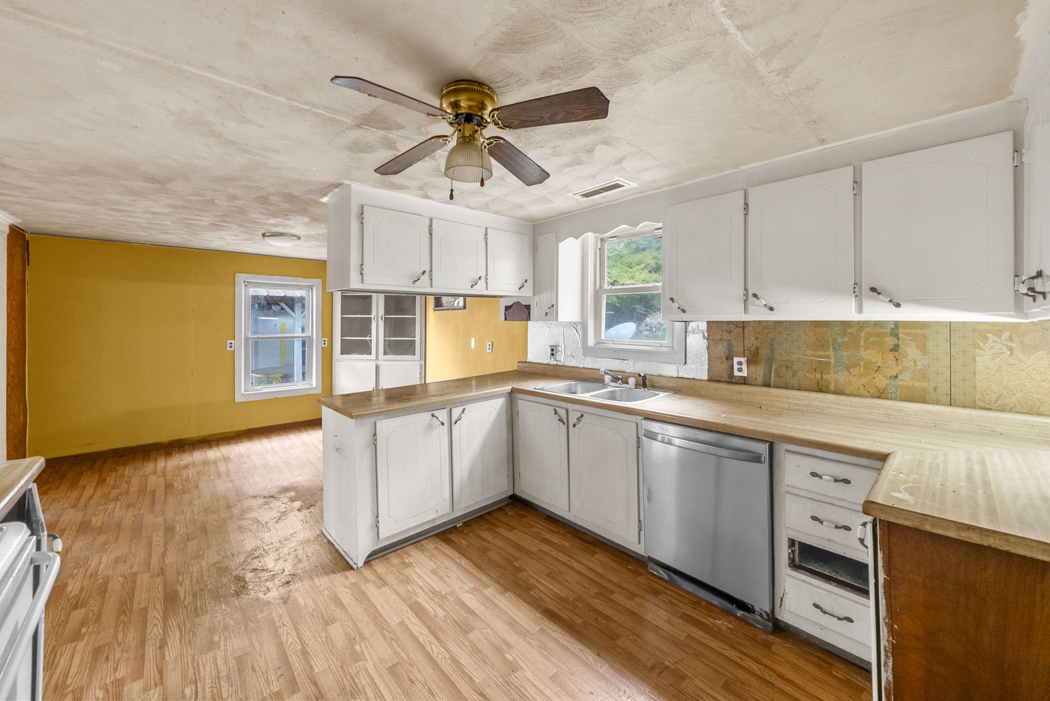 234 Lower Standing Rock Road Dover, TN 37058 - Photo 13 of 41 a kitchen with stainless steel appliances granite countertop a sink cabinets wooden floor and view living room