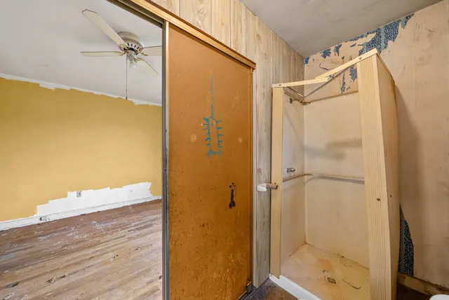 a bathroom with a shower and a glass door