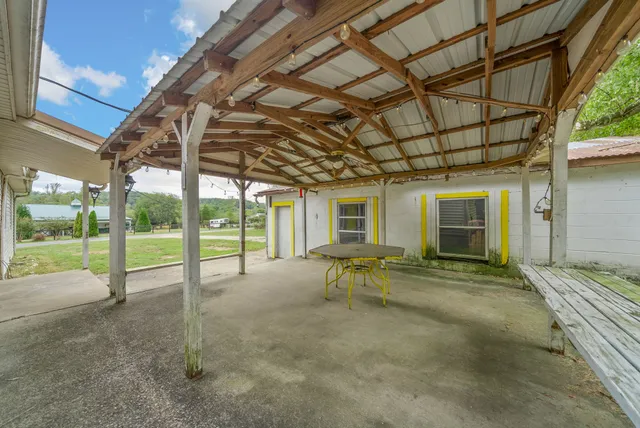 a view of a house with backyard porch and sitting area