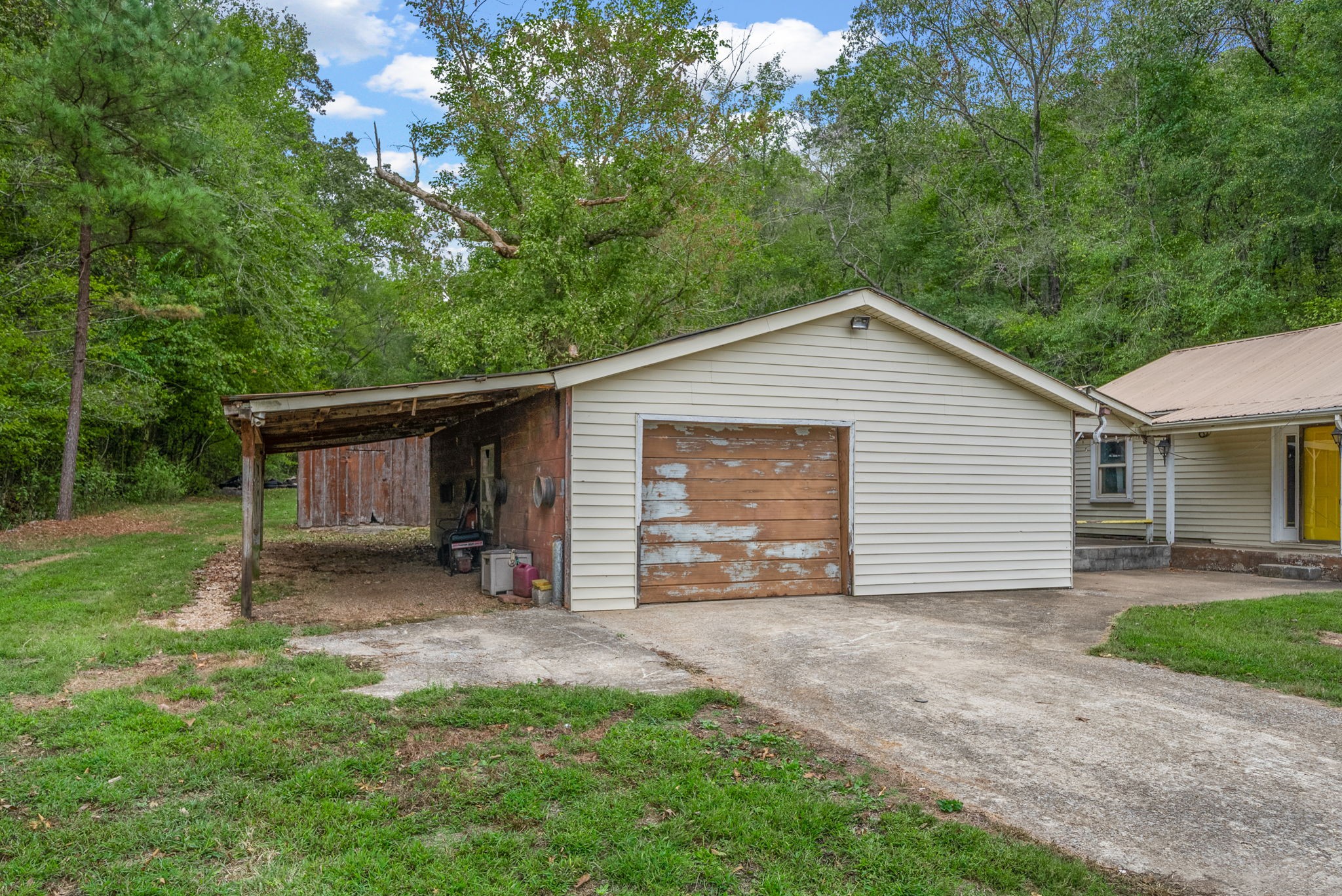 234 Lower Standing Rock Road Dover, TN 37058 - Photo 31 of 41 a view of a house with a small yard plants and a large tree
