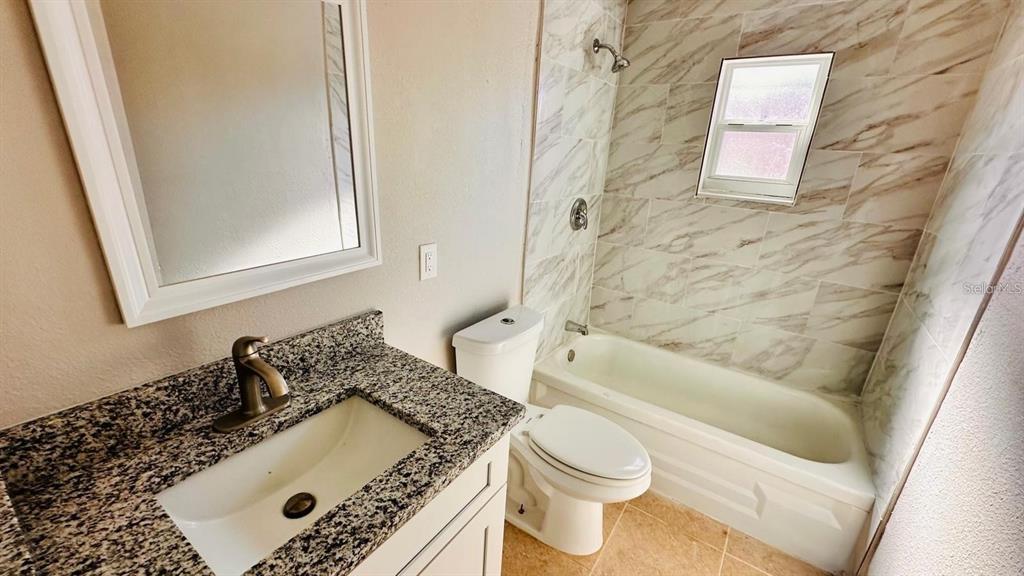 390 West Haines Boulevard, Unit 2 Lake Alfred, FL 33850 - Photo 7 of 7 a bathroom with a sink and toilet
