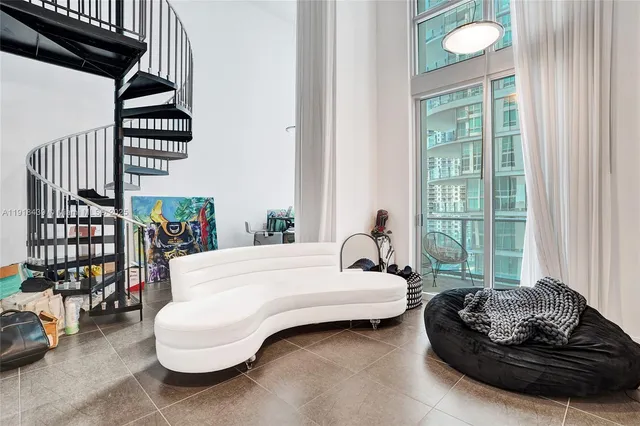 a spacious bedroom with a bed and a window