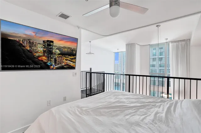 a bedroom with a bed and a painting on the wall