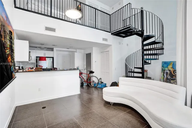 a view of front door with staircase and living room