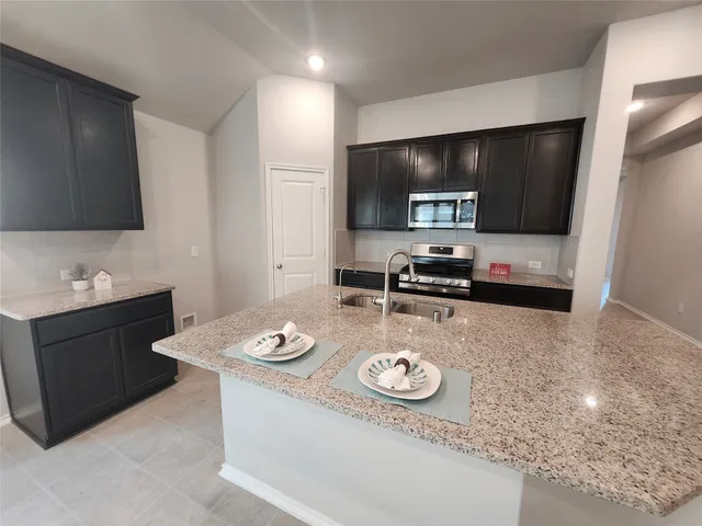 a kitchen with a sink stove and microwave