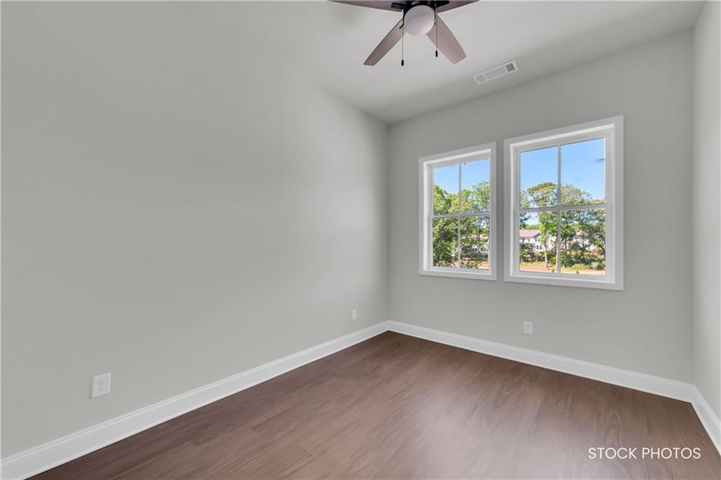 1038 Homestead Way Street Dacula, GA 30019 - Photo 20 of 36 an empty room with a window and wooden floor