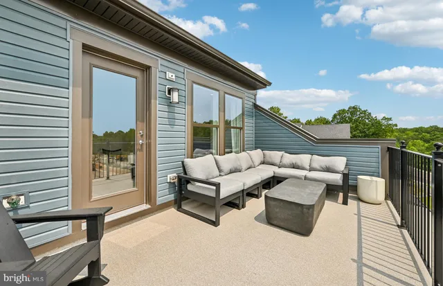 a view of a patio with swimming pool and sitting area