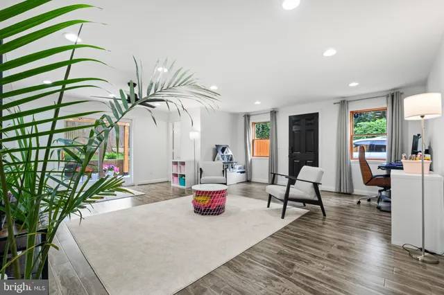 a living room with furniture and a potted plant