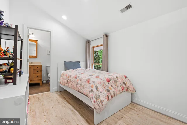 a bedroom with a large bed and a tv