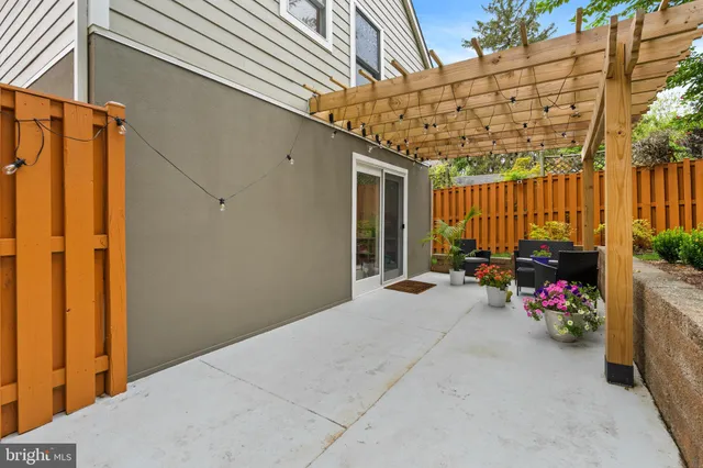 a view of a patio with table and chairs and potted plants