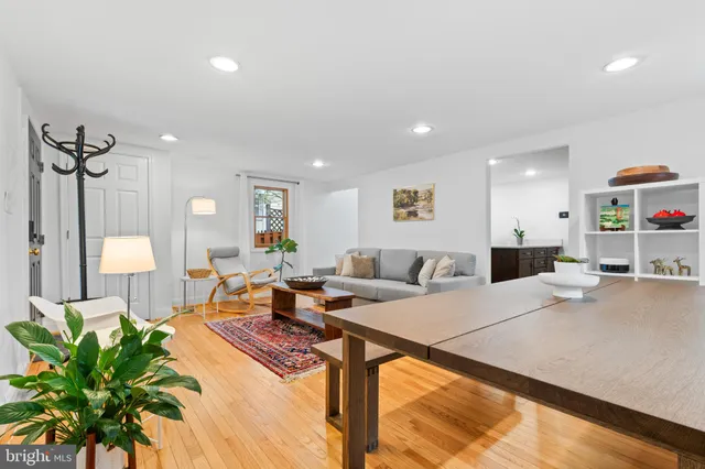 a living room with furniture a chandelier and a rug