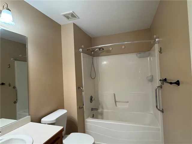a bathroom with a shower and a toilet