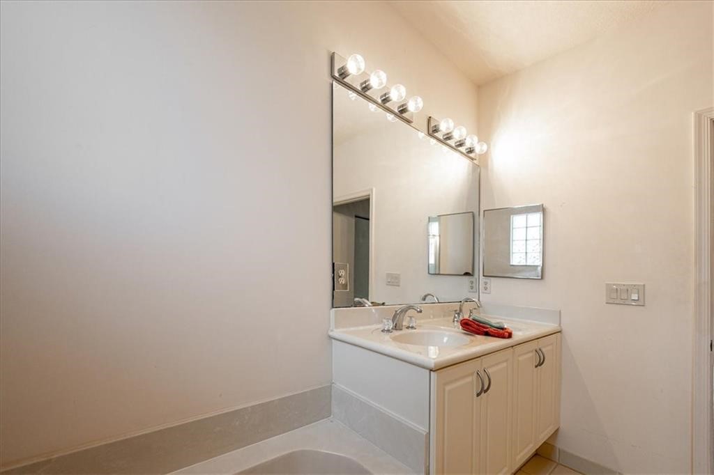 2597 Stockbridge Square Southwest, Unit 2597 Vero Beach, FL 32962 - Photo 14 of 21 a bathroom with a sink and a mirror