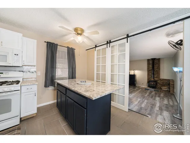 a kitchen with a stove a refrigerator and a sink