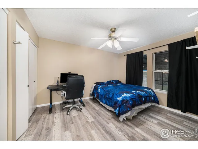 a living room with a bed furniture and a window
