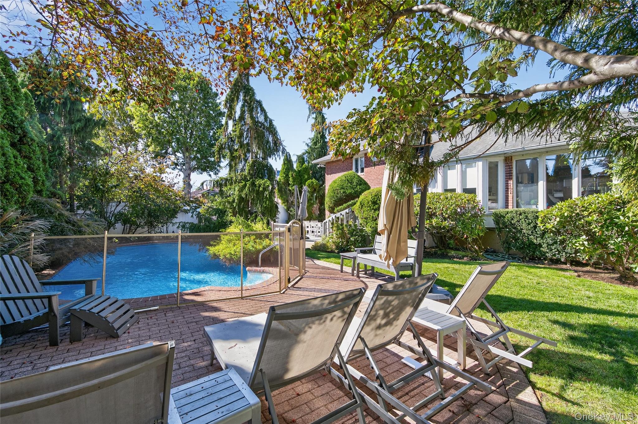 11 Sunbeam Road Syosset, NY 11791 - Photo 23 of 28 Backyard: In-ground heated saltwater swimming pool with patio area