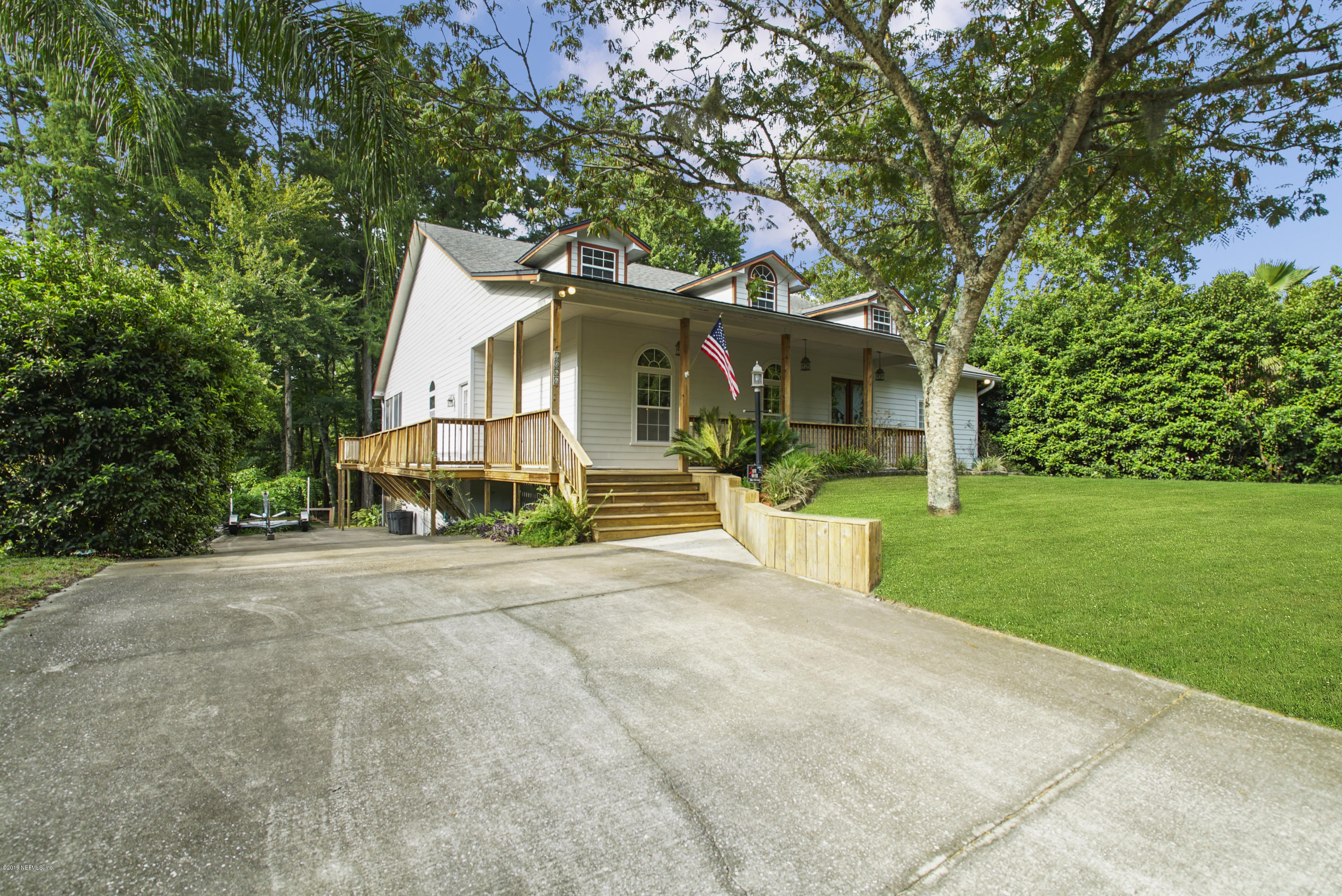2066 Cornell Road Middleburg, FL 32068 - Photo 1 of 43 a front view of a house with a yard and potted plants