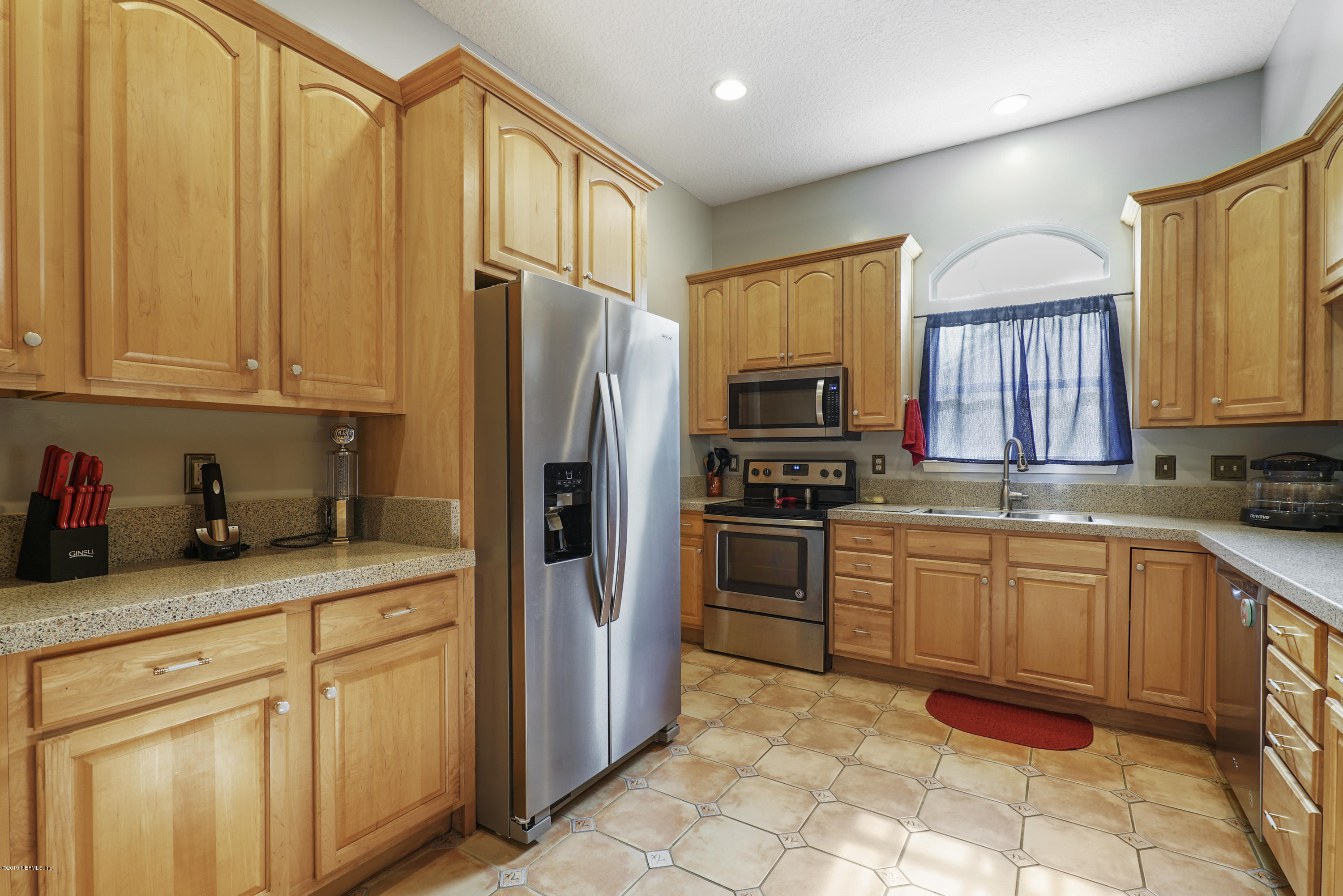 2066 Cornell Road Middleburg, FL 32068 - Photo 14 of 43 a kitchen with granite countertop cabinets stainless steel appliances and a counter space