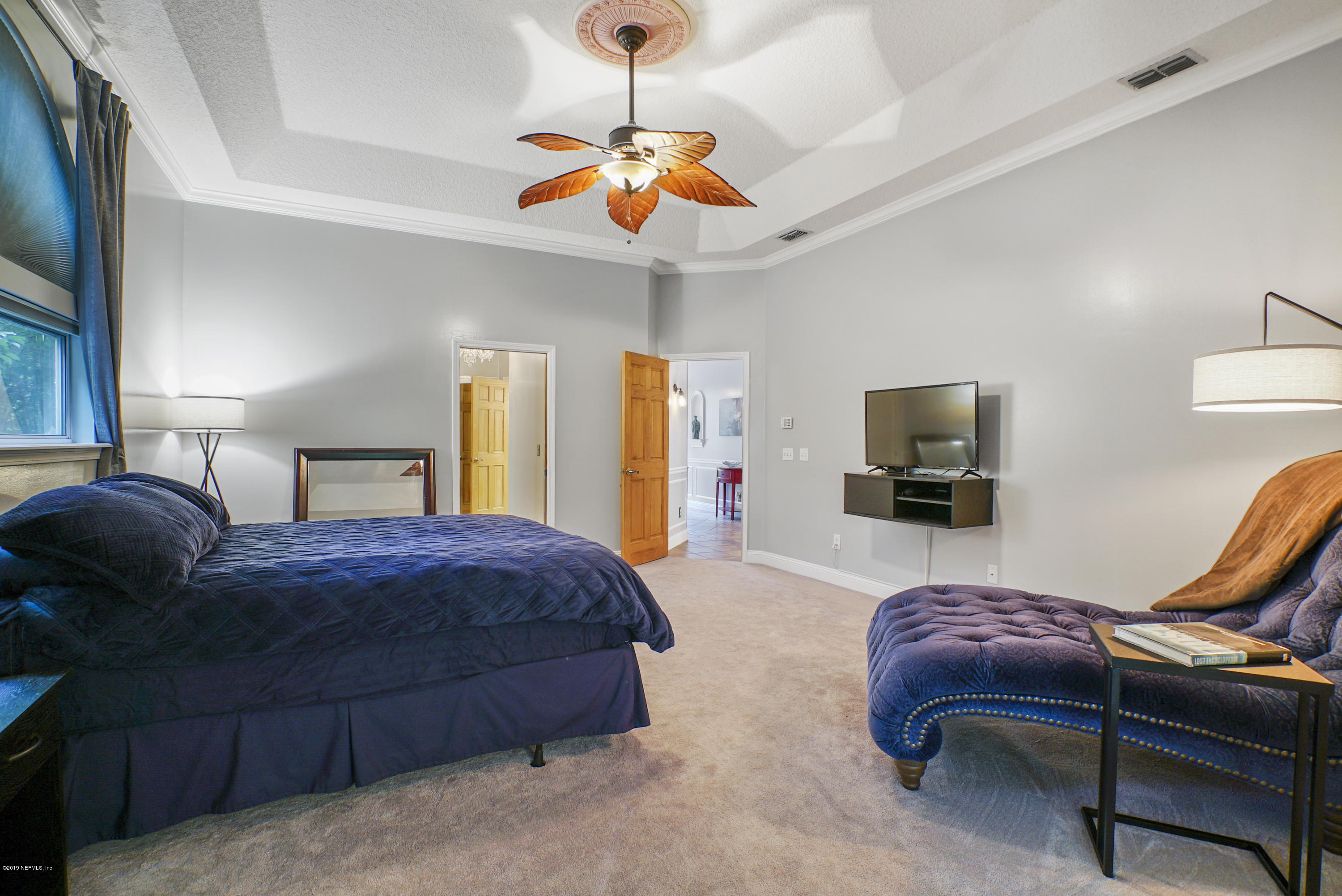 2066 Cornell Road Middleburg, FL 32068 - Photo 19 of 43 a bedroom with a bed and a chandelier