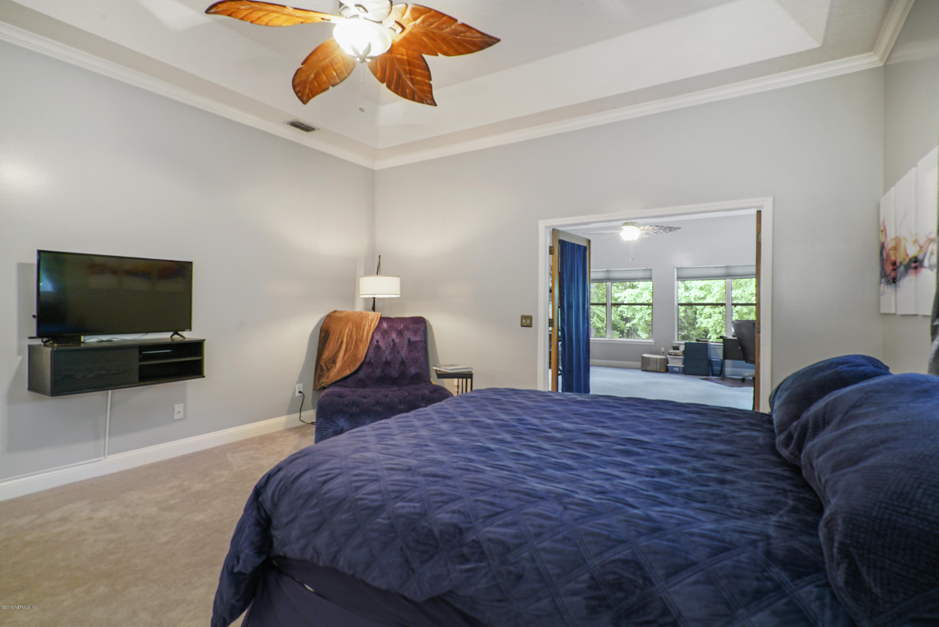 2066 Cornell Road Middleburg, FL 32068 - Photo 20 of 43 a bedroom with a bed and flat screen tv