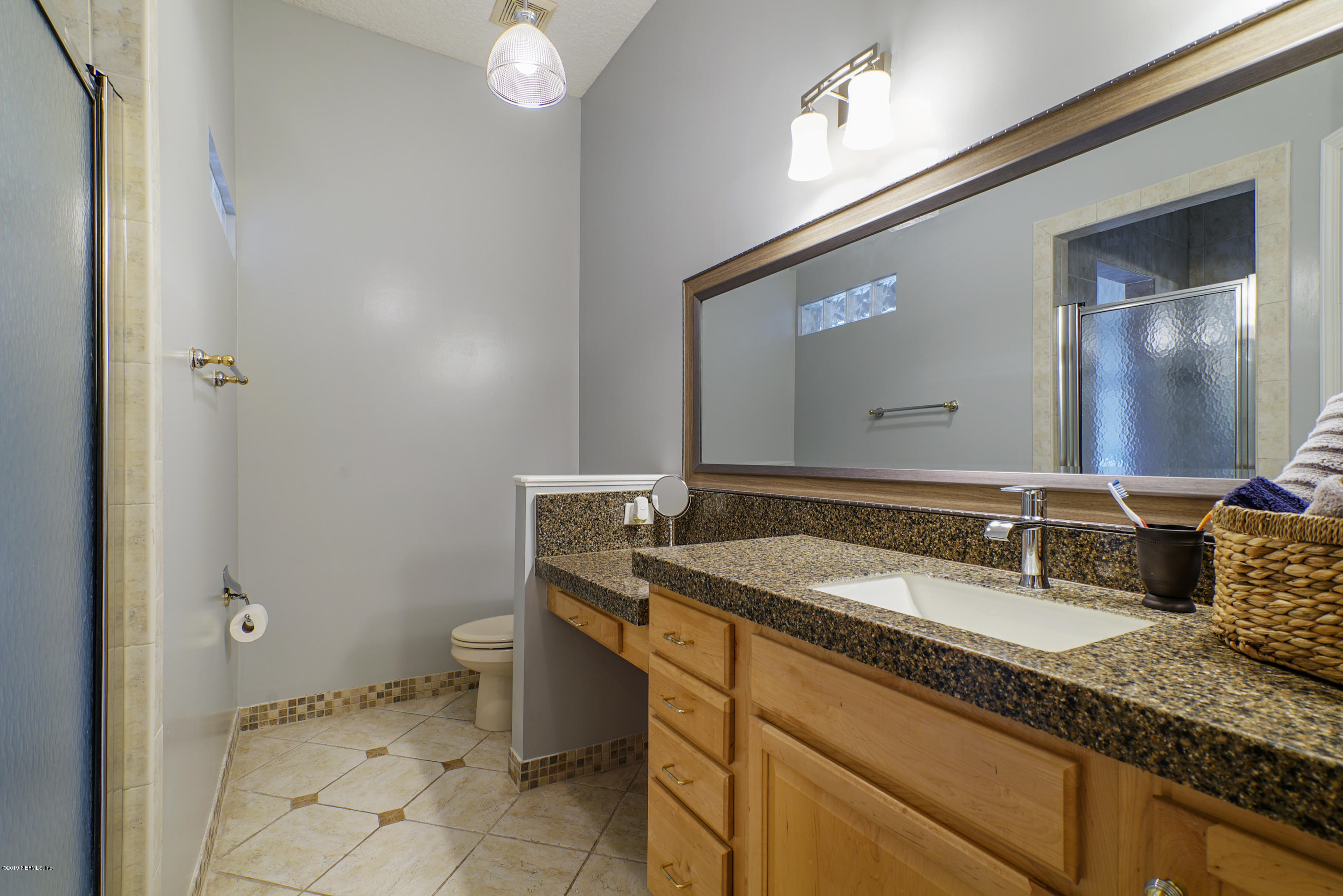 2066 Cornell Road Middleburg, FL 32068 - Photo 21 of 43 a bathroom with a granite countertop sink and a mirror