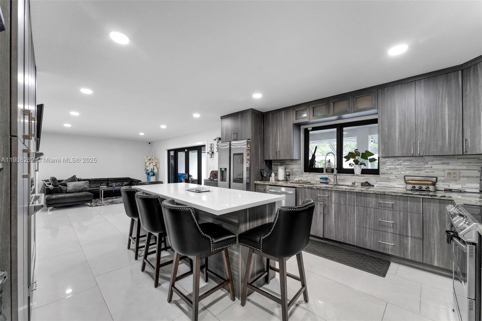 551 Southwest 127th Avenue Miami, FL 33184 - Photo 12 of 47 a kitchen with a table and chairs in it