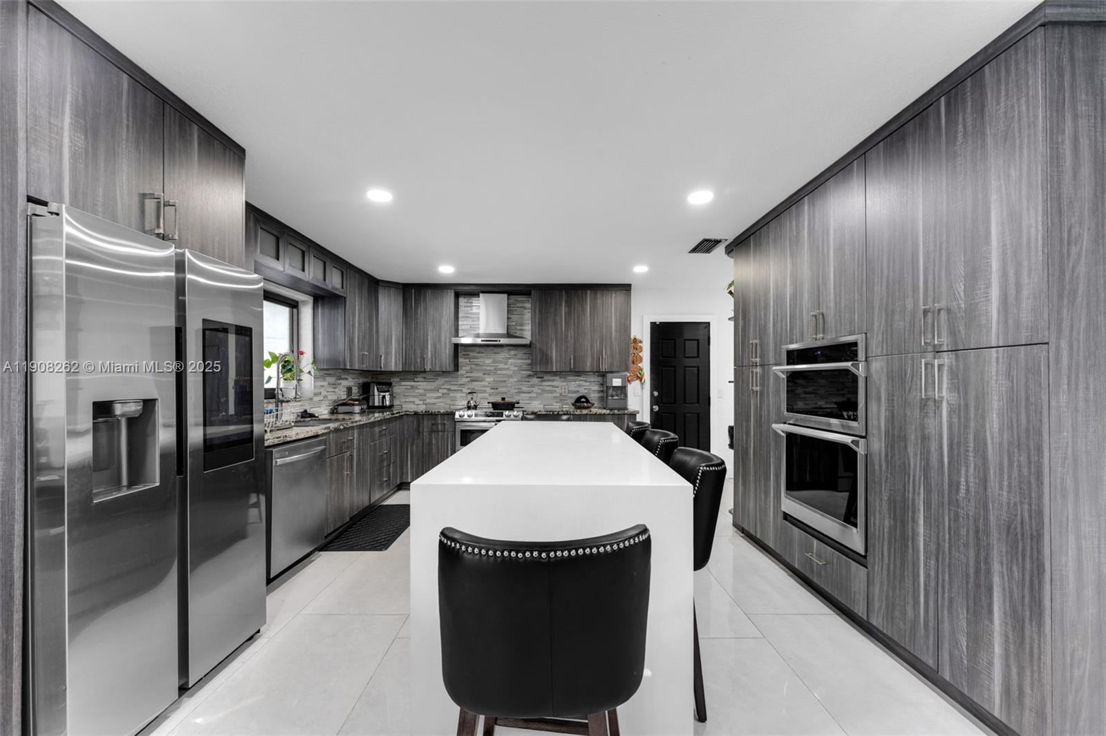 551 Southwest 127th Avenue Miami, FL 33184 - Photo 13 of 47 a large kitchen with a large counter top stainless steel appliances and cabinets