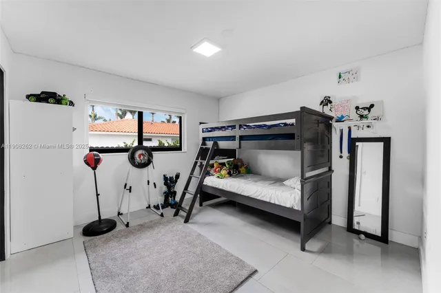 a bedroom with furniture and a window