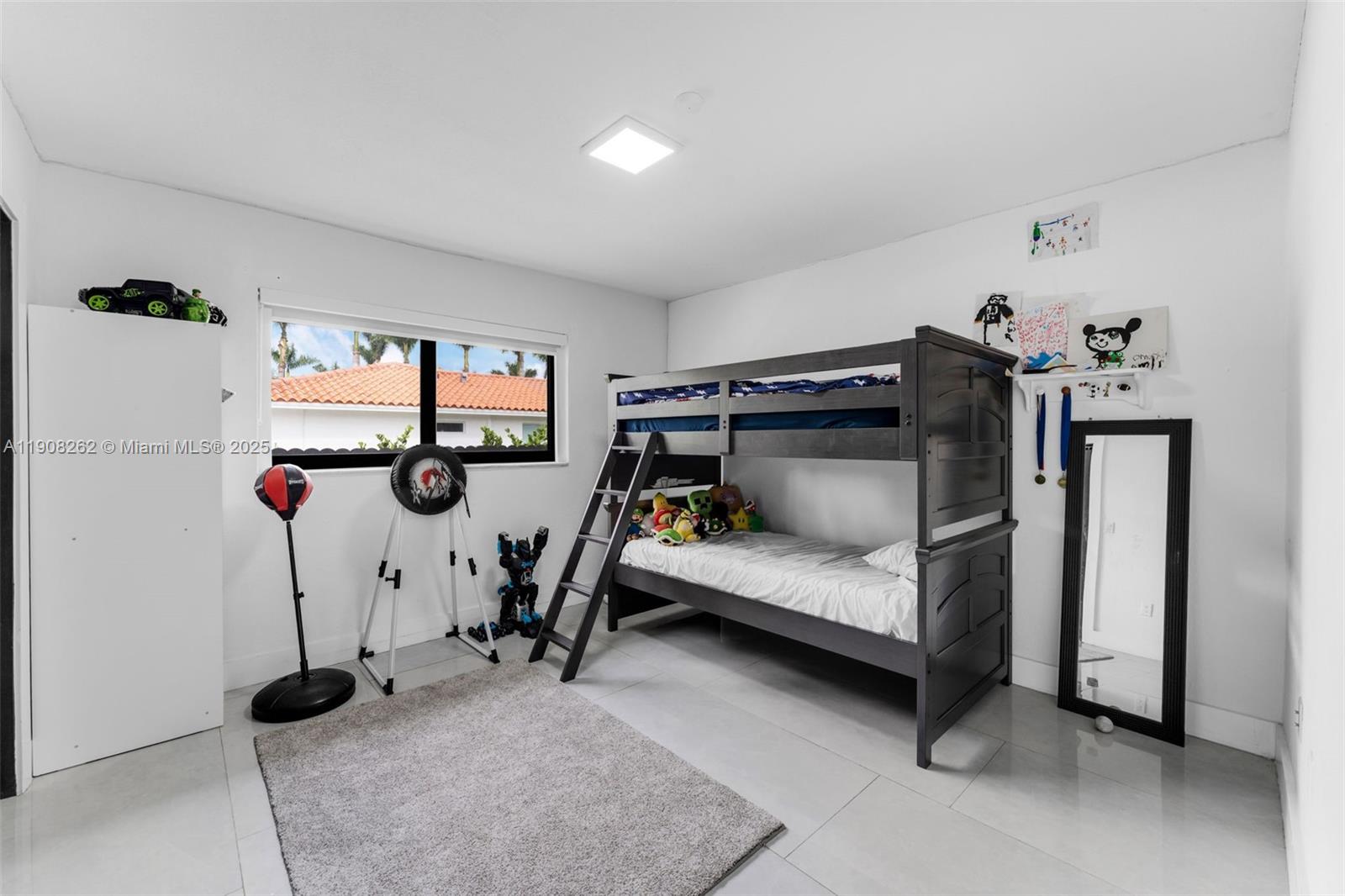 551 Southwest 127th Avenue Miami, FL 33184 - Photo 18 of 47 a bedroom with furniture and a window