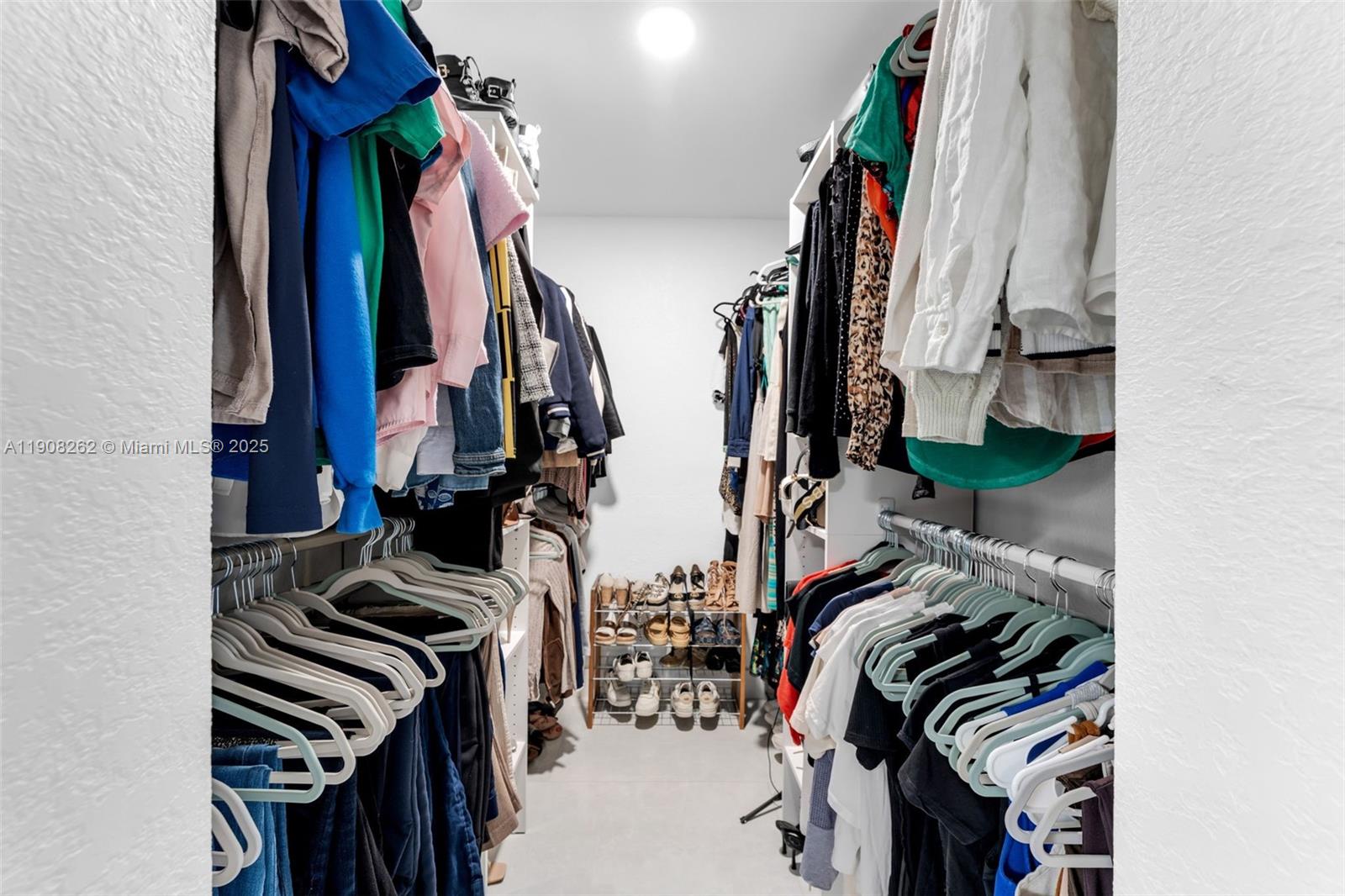 551 Southwest 127th Avenue Miami, FL 33184 - Photo 21 of 47 a view of walk in closet with clothes and shoes