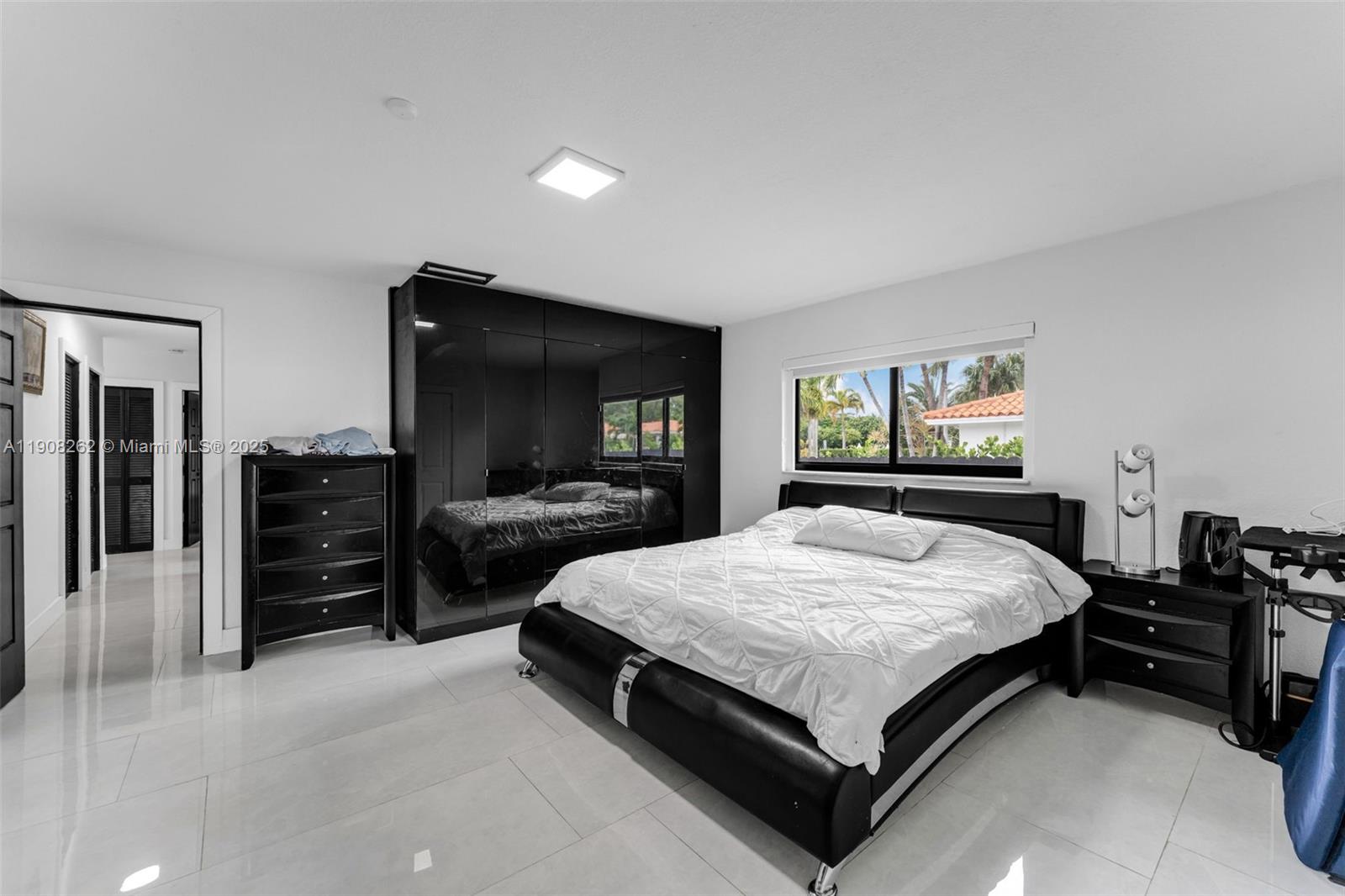 551 Southwest 127th Avenue Miami, FL 33184 - Photo 22 of 47 a bed room with a bed and a television